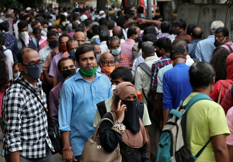 FILE PHOTO: People wait to board passenger buses during rush hour at a bus terminal, amidst the coronavirus disease (COVID-19) outbreak, in Mumbai, India, September 9, 2020. REUTERS/Niharika Kulkarni