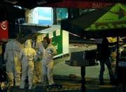 Investigators work outside a bar near the Stade de France where explosions were reported to have detonated outside the stadium during the France vs German friendly soccer match near Paris, November 13, 2015. REUTERS/Gonazlo Fuentes