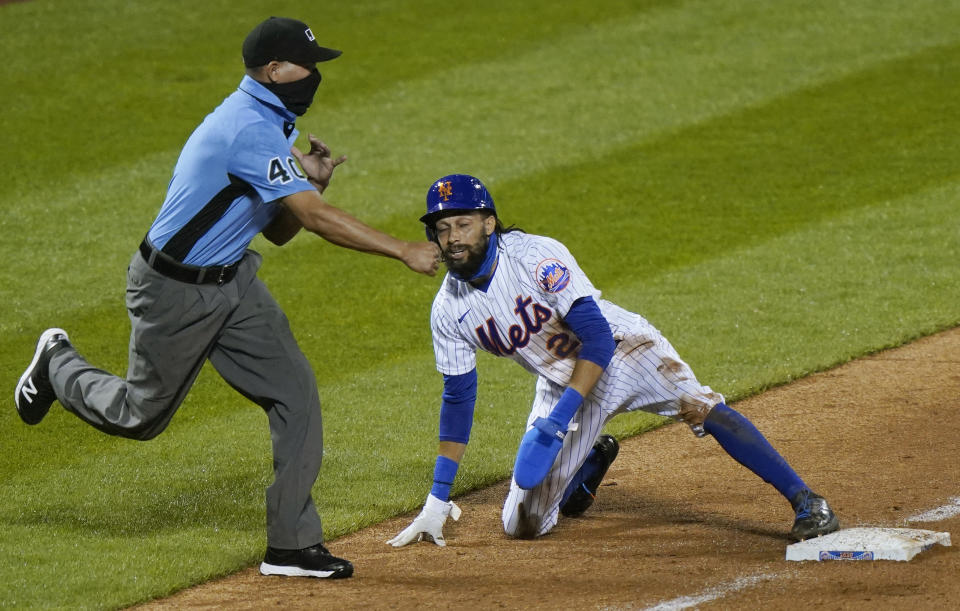 Third base umpire Roberto Ortiz (40) calls New York Mets'Billy Hamilton out on an attempted steal during the ninth inning of the team's baseball game against the New York Met, Thursday, Sept. 3, 2020, in New York. (AP Photo/Kathy Willens)