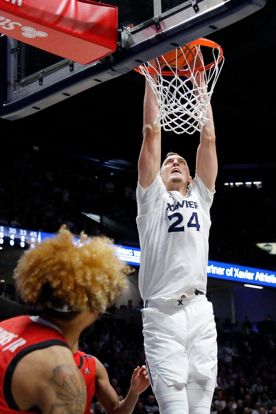 Xavier Musketeers forward Jack Nunge (24) dunks in the first half of the 89th Annual Crosstown Shootout basketball game between the Xavier Musketeers and the Cincinnati Bearcats at the Cintas Center in Cincinnati on Saturday, Dec. 11, 2021. Xavier led 42-27 at halftime. 
