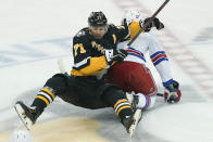 Pittsburgh Penguins' Evgeni Malkin (71) topples over New York Rangers' Kevin Rooney (17) during the first period of an NHL hockey game, Saturday, Feb. 26, 2022, in Pittsburgh. (AP Photo/Keith Srakocic)