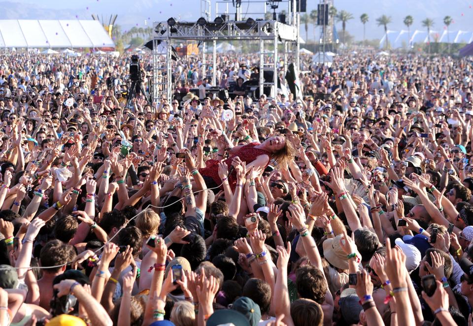 crowds at coachella carrying a woman in 2011