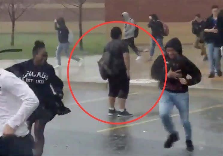 Video shows high schooler standing completely still during hail storm. Screenshot from Twitter