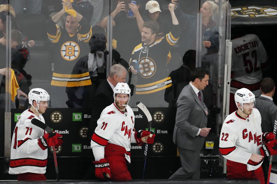 Carolina Hurricanes coach Rod Brind'Amour, second from right, leaves the bench with Jesper Fast (71), Jordan Staal (11) and Brett Pesce (22) after the team's loss to the Boston Bruins in Game 6 of an NHL hockey Stanley Cup first-round playoff series Thursday, May 12, 2022, in Boston. (AP Photo/Michael Dwyer)