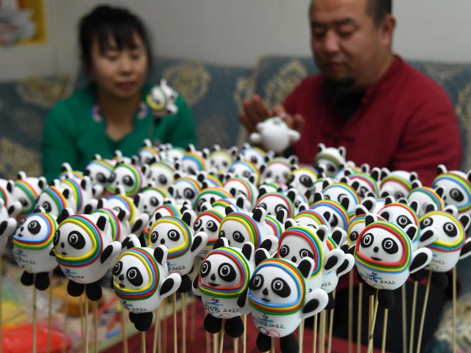 Dong Hui and his wife show the dough figurines of Bing Dwen Dwen, the mascot of the 2022 Beijing Winter Olympics, at home in Shenyang city in northeast Chinas Liaoning province Thursday, Feb. 10, 2022. The couple said they were making these mascots for their friends and relatives.