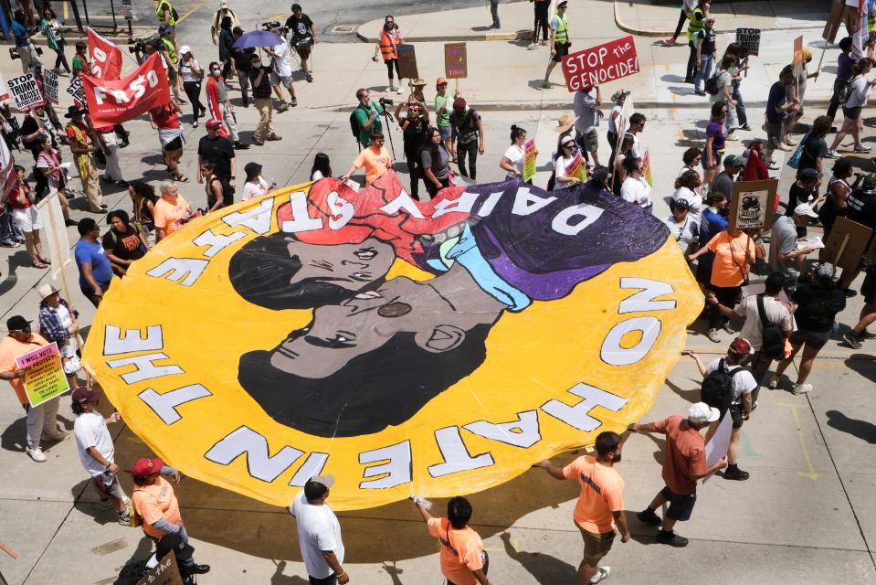 A ‘No Hate in the Dairy State’ sign is held by protesters during the Coalition to March protest on the RNC 2024 Monday, July 15, 2024, around in Milwaukee.