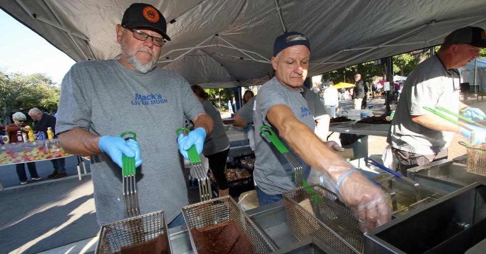 Donnie Mayhew and Ron McKee, with Mack’s Liver Mush, deep fry liver mush during the Mush, Music and Mutts Festival held Saturday, Oct. 15, 2022, at Court Square in Uptown Shelby.