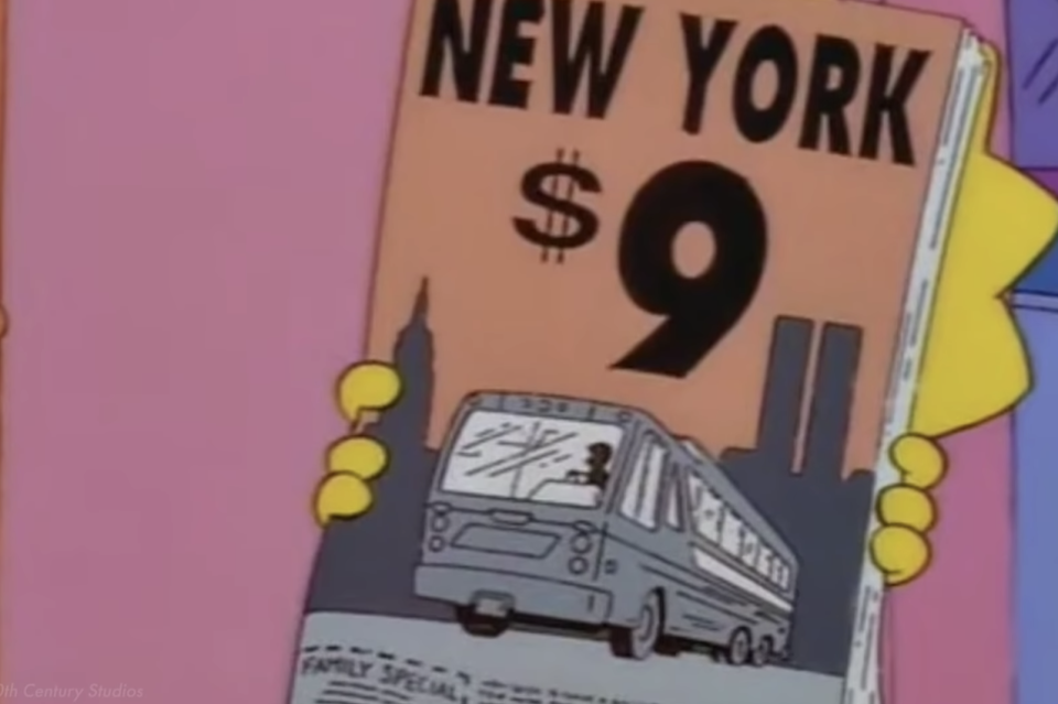 Lisa holding a brochure advertising something for $9 with the Twin Towers, looking like an "11," in the background