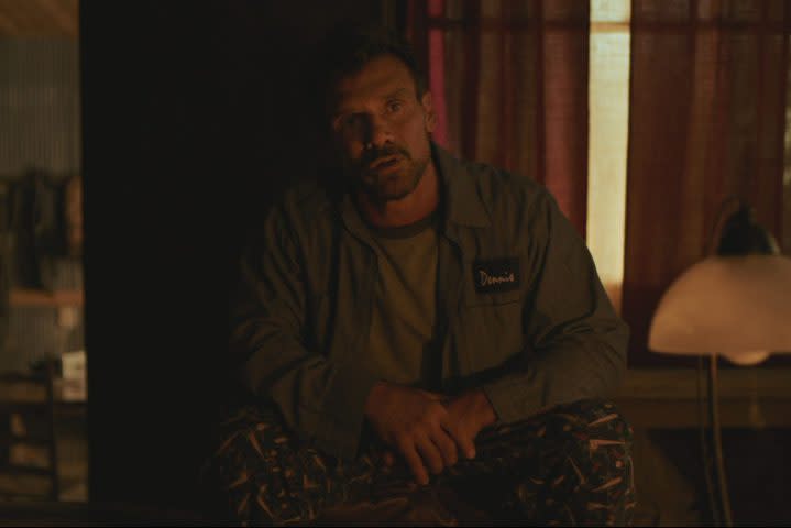 Frank Grillo sitting down and staring in a scene from Paradise Highway.