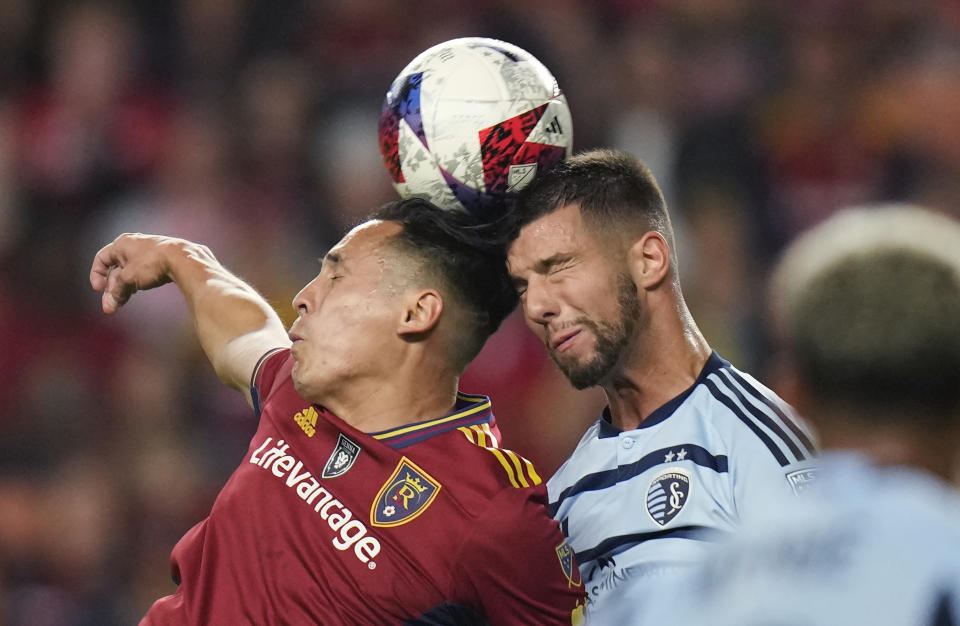 Real Salt Lake forward Rubio Rubin, left, and Sporting Kansas City defender Robert Voloder vie for a head ball during the first half of an MLS soccer match Saturday, Oct. 7, 2023, in Sandy, Utah. (AP Photo/Rick Bowmer)