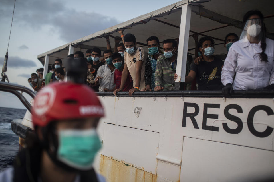 Migrants from different nationalities, mainly from Somalia, Egypt and Morocco, but also from Libya, Sierra Leone, Ivory Coat, Bangladesh, Senegal, Syria, Palestine, Benin and Tunisia, including 14 minors and 4 women, rest on board the Spanish NGO Open Arms vessel on Wednesday 9, 2020, after being rescued last Tuesday night as they were trying to flee Libya on board a precarious wooden boat, in international waters, in the Central Mediterranean sea. (AP Photo/Santi Palacios)