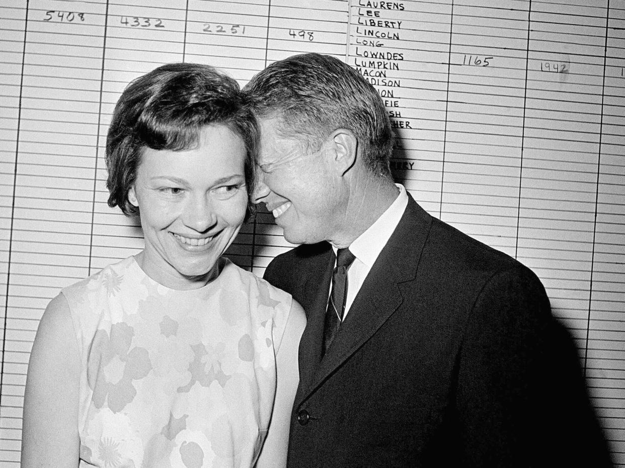 In a photograph from September 1966, then Georgia State Sen. Jimmy Carter hugs his wife, Rosalynn, at his Atlanta campaign headquarters.