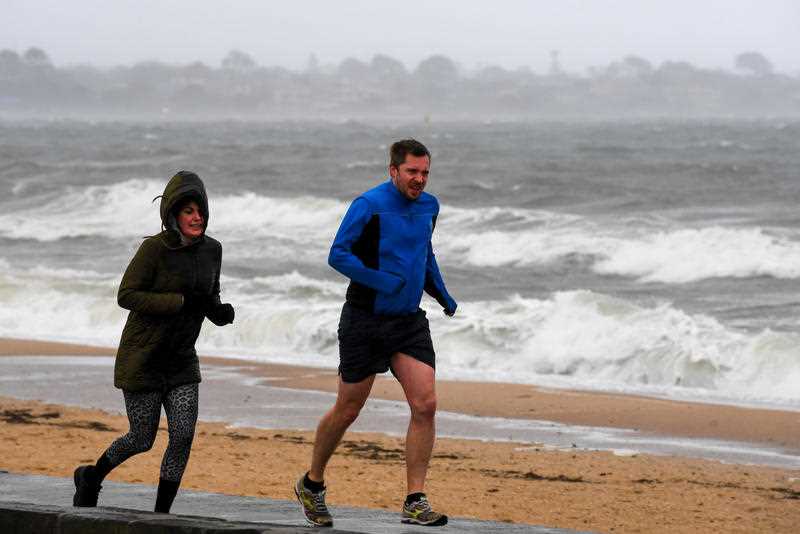 Joggers are seen at Elwood Beach, Melbourne.