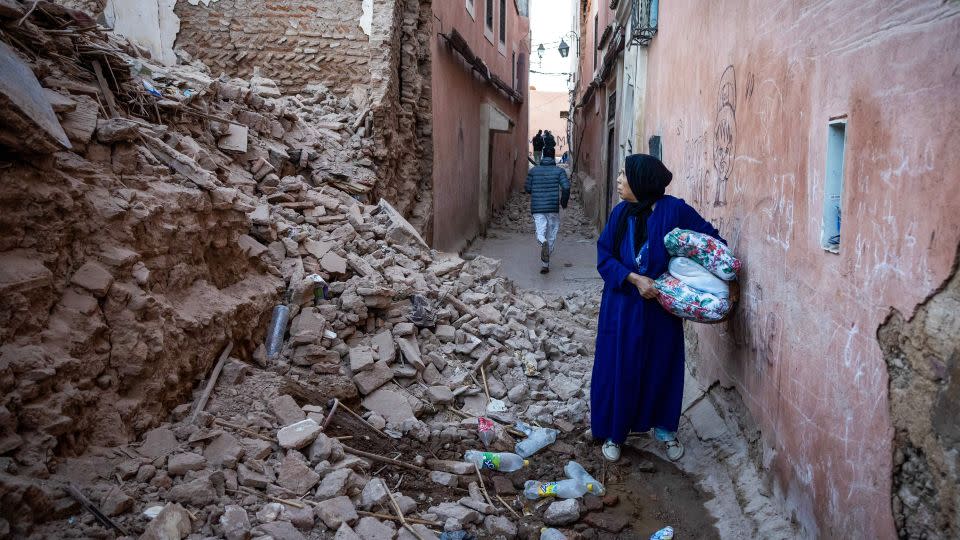 A woman stands among the rubble of a building in the earthquake-damaged old city of Marrakech. - Fadel Senna/AFP/Getty Images