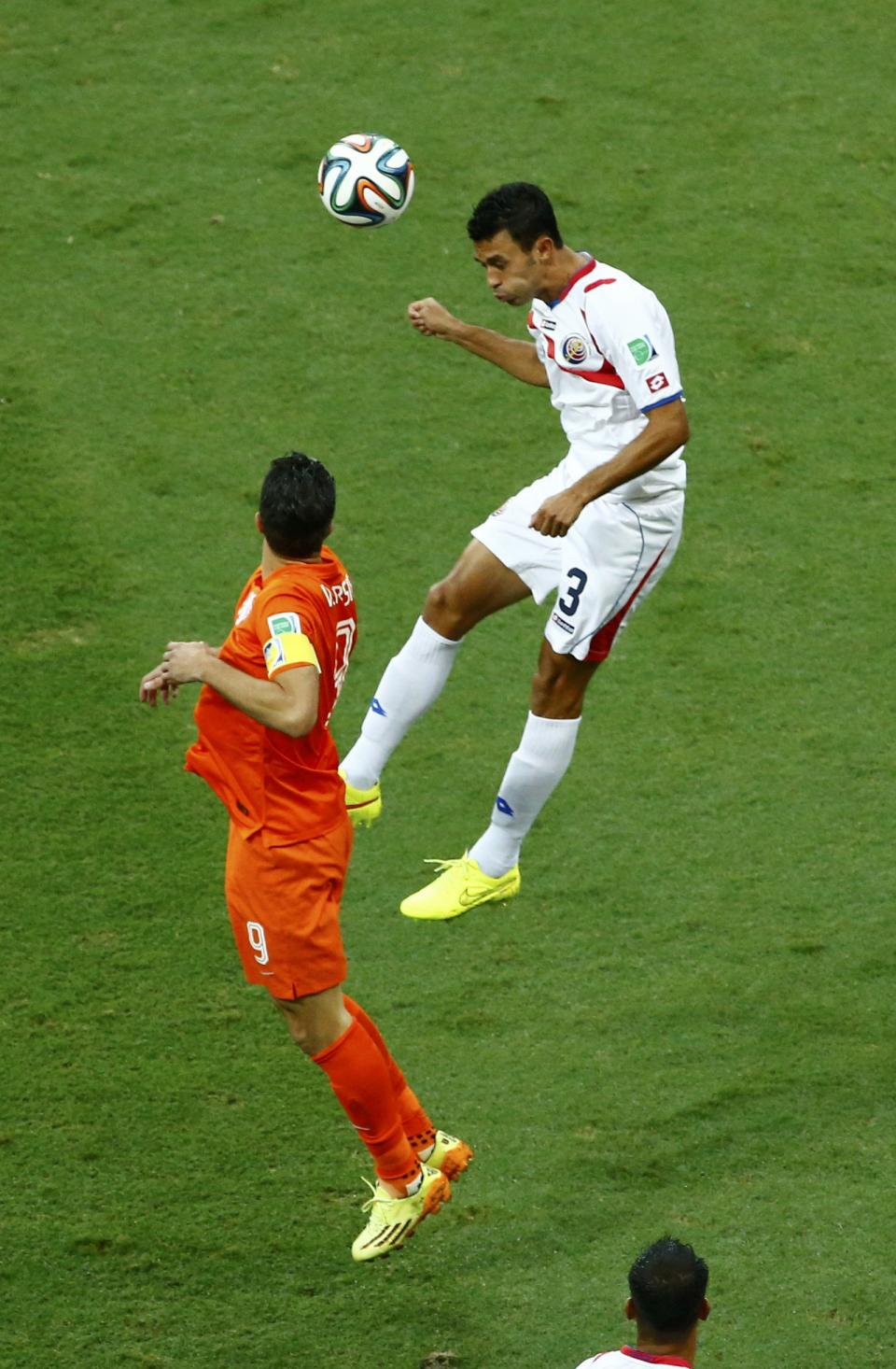 Robin van Persie of the Netherlands jumps for the ball with Costa Rica's Giancarlo Gonzalez during their 2014 World Cup quarter-finals at the Fonte Nova arena in Salvador July 5, 2014. REUTERS/Ruben Sprich
