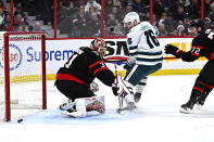 Ottawa Senators goaltender Anton Forsberg (31) makes a save on San Jose Sharks centre Steven Lorentz (16) during the first period of an NHL hockey game Saturday, Dec. 3, 2022, in Ottawa, Ontario. (Justin Tang/The Canadian Press via AP)