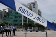 Police officers stand guard outside Apple Daily headquarters as Hong Kong media tycoon Jimmy Lai, who founded local newspaper Apple Daily, is arrested by police at his home in Hong Kong on Aug. 10, 2020. The Apple Daily editors and executives were detained Thursday, June 17, 2021, under a national security law that took effect last year.(AP Photo/Vincent Yu, File)