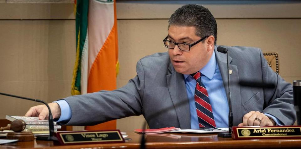 City Commissioner Ariel Fernandez passes out copies of Robert’s Rules of Order to other members of the Coral Gables Commission during the Sept. 13, 2023 City Commission meeting, during which commissioners voted against moving local elections from April in odd years to November in even years.