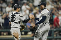 New York Yankees catcher Kyle Higashioka (66) and relief pitcher Aroldis Chapman react after defeating the Baltimore Orioles 7-2 during a baseball game, Tuesday, Sept. 14, 2021, in Baltimore. (AP Photo/Julio Cortez)