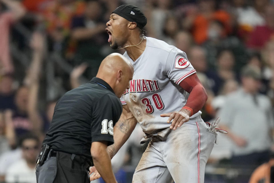 Cincinnati Reds' Will Benson (30) reacts after scoring a run on Kevin Newman's RBI-double during the seventh inning of a baseball game against the Houston Astros, Friday, June 16, 2023, in Houston. (AP Photo/Eric Christian Smith)