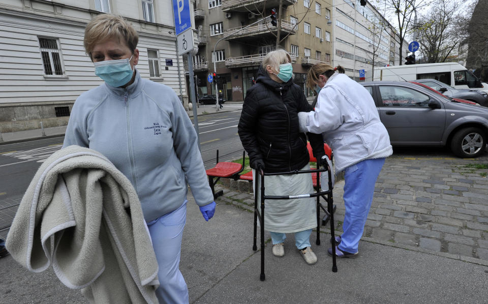 People walk on the street after an earthquake in Zagreb, Croatia, Sunday, March 22, 2020. A strong earthquake shook Croatia and its capital on Sunday, causing widespread damage and panic. (AP Photo)