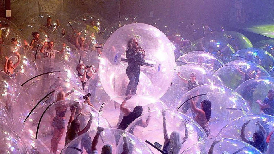 The Flaming Lips perform to audience members in bubbles