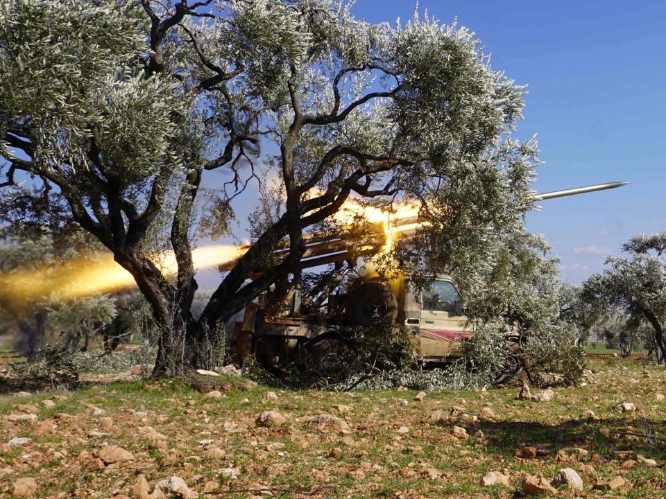 Members of Syria's opposition National Liberation Front remotely-fire a rocket at a position near the village of al-Nayrab: AFP via Getty Images