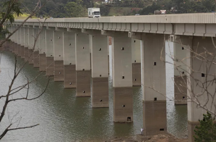 FILE - A bridge's columns are marked by the previous water line over the Atibainha reservoir, part of the Cantareira System that provides water to the Sao Paulo metropolitan area, in Nazare Paulista, Brazil, on Jan. 29, 2015. The intensity of extreme drought and rainfall has “sharply” increased over the past 20 years, according to a study published Monday, March 13, 2023, in the journal Nature Water. (AP Photo/Andre Penner, File)