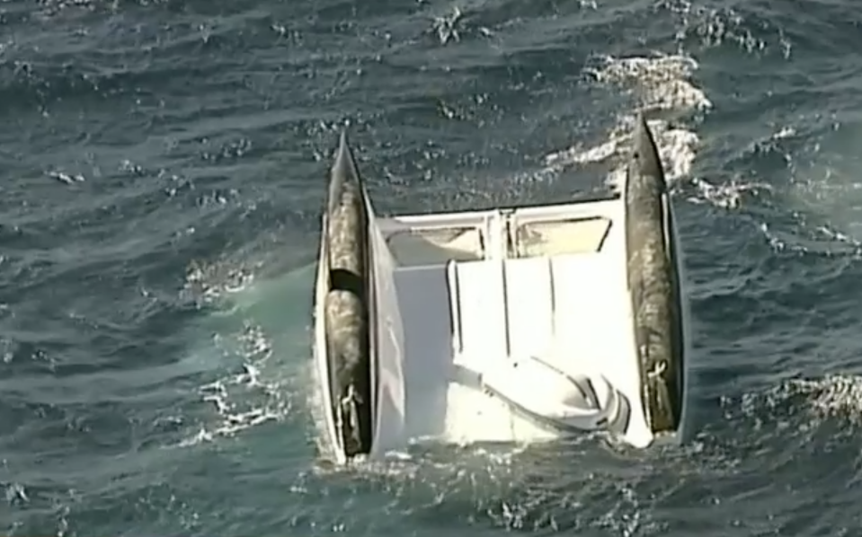 Three bodies were found in the water around a catamaran which capsized off Stockton Beach,  Newcastle. 