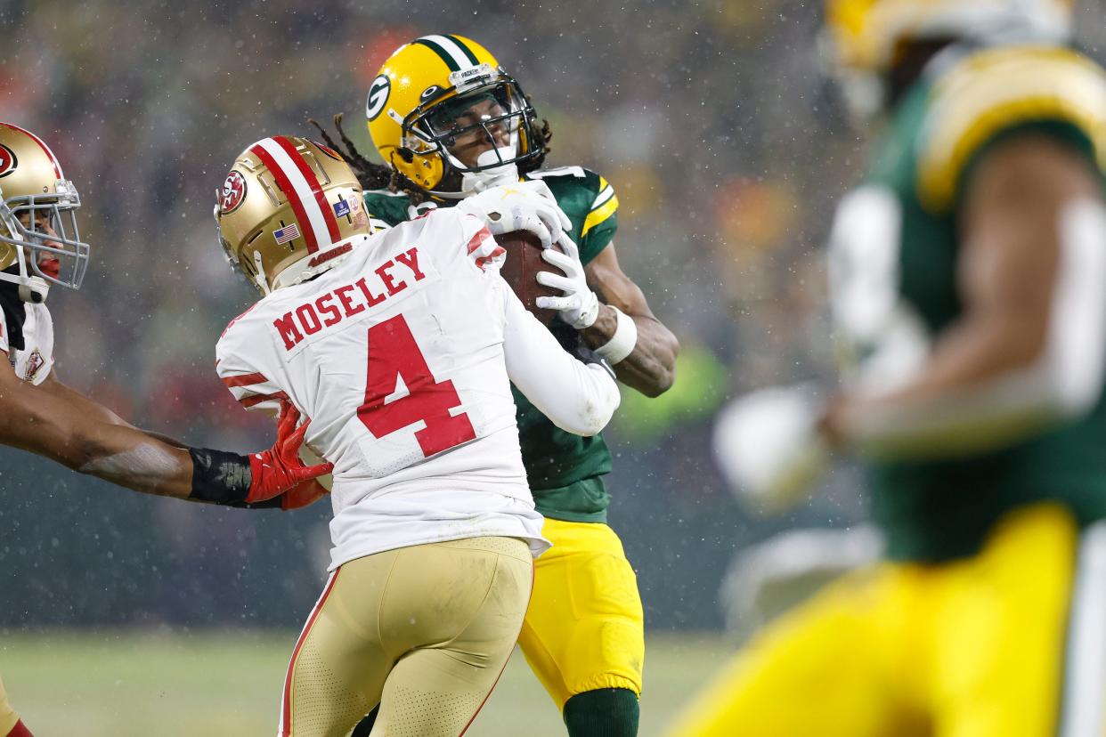 Jan 22, 2022; Green Bay, Wisconsin, USA; Green Bay Packers wide receiver Davante Adams (17) carries the ball as San Francisco 49ers cornerback Emmanuel Moseley (4) defends in the second half during a NFC Divisional playoff football game at Lambeau Field. Mandatory Credit: Jeff Hanisch-USA TODAY Sports