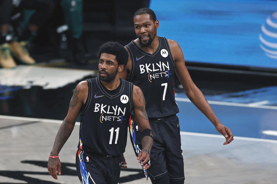 FILE - Brooklyn Nets guard Kyrie Irving (11) and Kevin Durant react against the Boston Celtics in the second half of Game 5 during an NBA basketball first-round playoff series, Tuesday, June 1, 2021, in New York. Kevin Durant has requested a trade from the Brooklyn Nets, according to a person with direct knowledge of the seismic decision that undoubtedly will have teams scrambling to put together enormous offers for the perennial All-Star. The news on Durant also came three days after Kyrie Irving decided to exercise his $37 million option to remain with Brooklyn this coming season. (AP Photo/Adam Hunger, File)