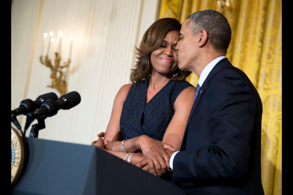 President Barack Obama kisses first lady Michelle Obama during her remarks at an Affordable Care Act reception in the East Room of the White House on&nbsp;May 1, 2014.