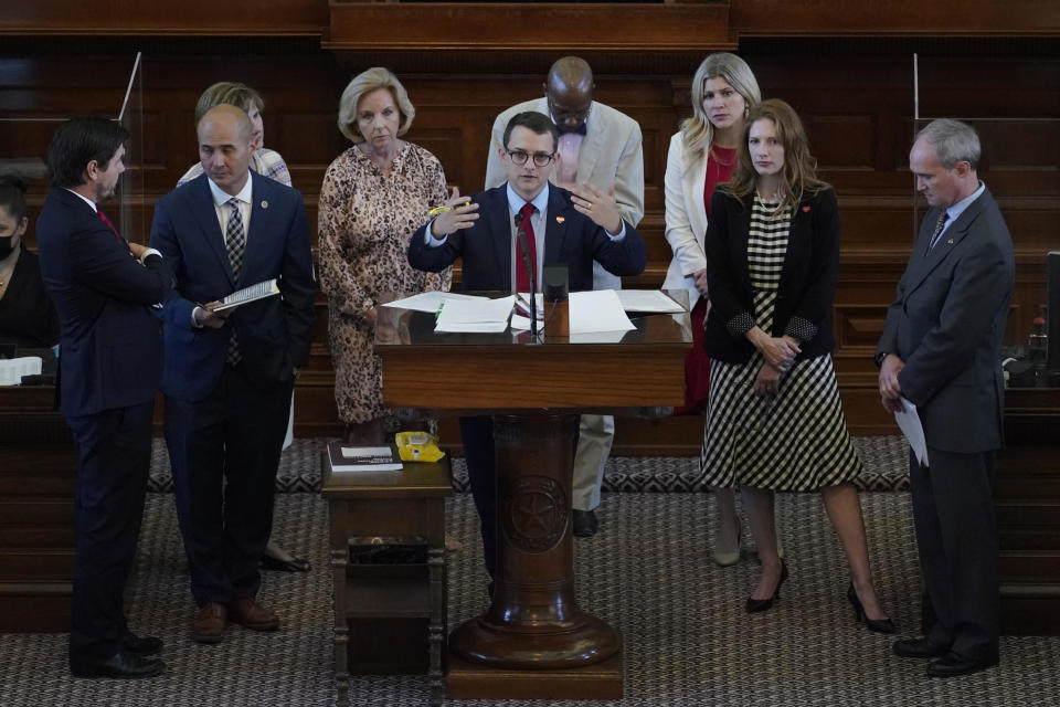 Representative Briscoe Cain, R-Houston, center, stands with co-sponsors as he answers questions and speaks in favor an election bill in the House Chamber at the Texas Capitol in Austin on May 6, 2021. / Credit: Eric Gay / AP