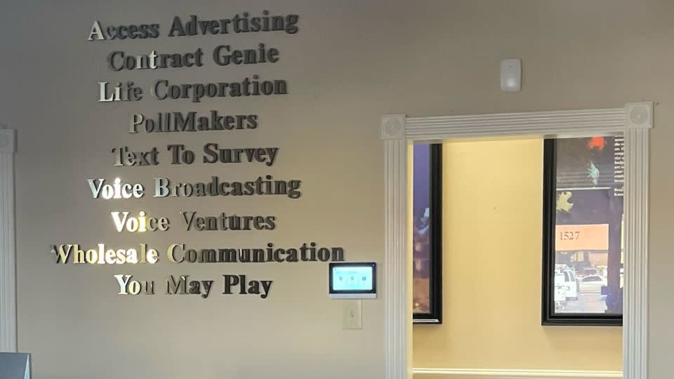 A sign on the wall of Life Corporation’s strip mall office lists various other companies it’s tied to, several of which have a long history of involvement in politics. - CNN