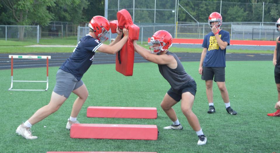 Seniors Nolan Laskey (left) and Cooper Miller square off during a drill in Bedford football practice.