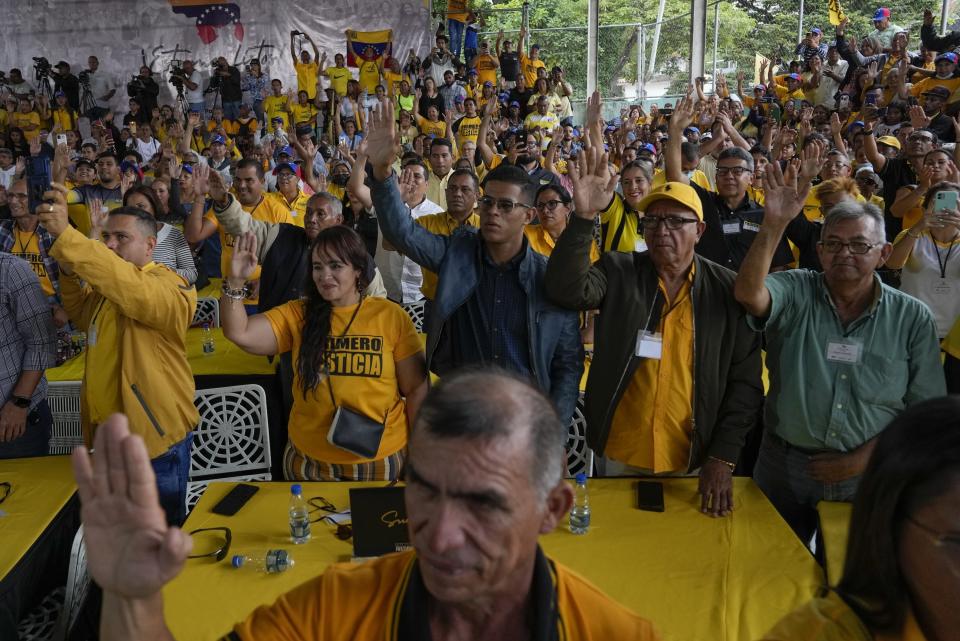 FILE - Supporters of opposition leader and former presidential candidate Henrique Capriles raise their hands as they take an oath to support him as the presidential candidate for the Primero Justicia party ahead of the opposition primary in Caracas, Venezuela, Friday, March 10, 2023. Opposition parties for years encouraged voters to boycott elections before urging them to participate in the planned October 2023 primary election to chose a single candidate to face current President Nicolas Maduro at the ballot box. (AP Photo/Ariana Cubillos, File)