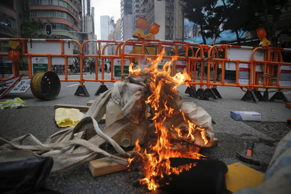 Burning debris is seen on a street during a protest against Beijing's national security legislation in Hong Kong, Sunday, May 24, 2020. Hundreds of protesters took to the streets Sunday to march against China's proposed tough national security legislation for the city. (AP Photo/Kin Cheung)