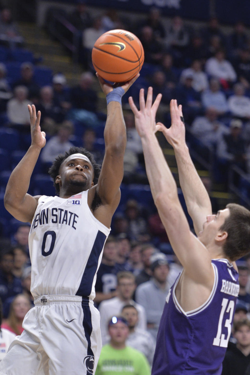 Penn State's Kanye Clary (0) shoots against Northwestern's Brooks Barnhizer (13) during the first half of an NCAA college basketball game Wednesday, Jan. 10, 2024, in State College, Pa. (AP Photo/Gary M. Baranec)