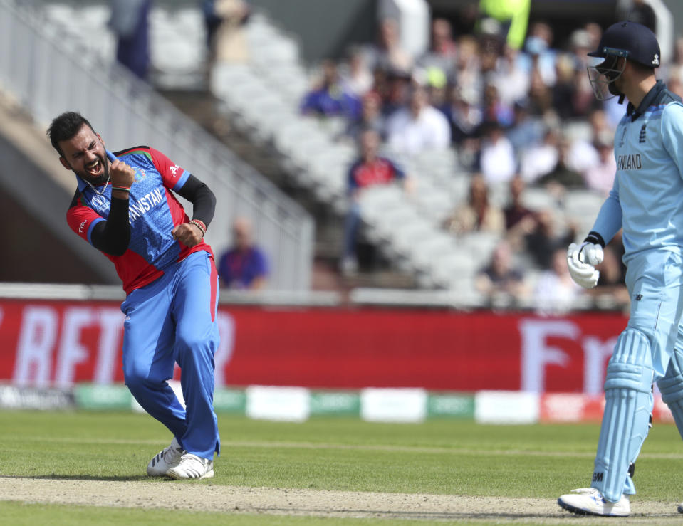 Afghanistan's Dawlat Zadran, left, celebrates the dismissal of England's James Vince, right, during the Cricket World Cup match between England and Afghanistan at Old Trafford in Manchester, England, Tuesday, June 18, 2019. (AP Photo/Rui Vieira)