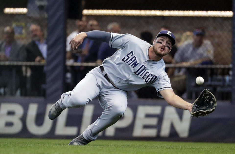 FILE - In this Sept. 19, 2019, file photo, San Diego Padres' Hunter Renfroe makes a diving catch on a ball hit by Milwaukee Brewers' Lorenzo Cain during the first inning of a baseball game in Milwaukee. The Padres have acquired outfielder Tommy Pham and infielder-pitcher Jake Cronenworth from the Tampa Bay Rays for Renfroe, minor league infielder Xavier Edwards and a player to be named. (AP Photo/Morry Gash, File)