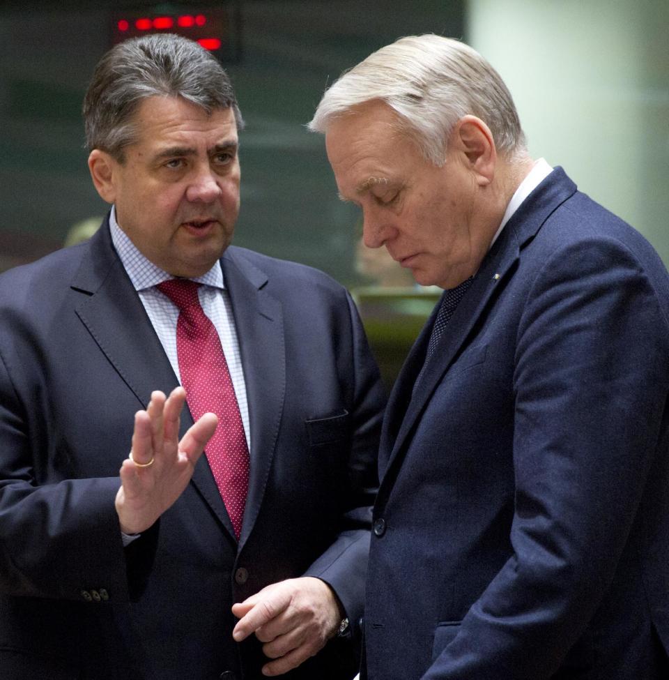 German Foreign Minister Sigmar Gabriel, left, speaks with French Foreign Minister Jean-Marc Ayrault during a meeting of EU foreign ministers at the EU Council building on Monday, Feb. 6, 2017. (AP Photo/Virginia Mayo)