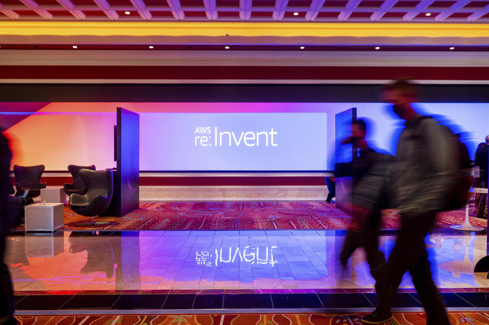 IMAGE DISTRIBUTED FOR AMAZON WEB SERVICES - Attendees pass a display at AWS re:Invent 2021, a conference hosted by Amazon Web Services (AWS), on Wednesday, Dec. 1, 2021, at The Venetian in Las Vegas. (Noah Berger/Amazon Web Services via AP Images)