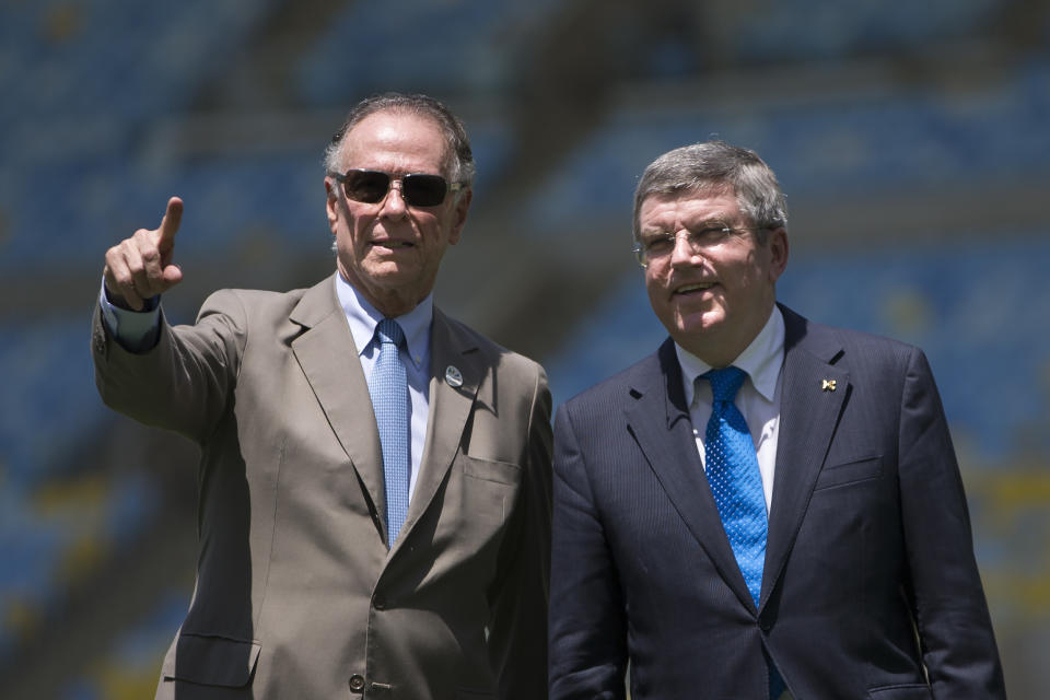 FILE - President of Brazil's Olympic Committee Carlos Arthur Nuzman, left, and International Olympic Committee (IOC) President Thomas Bach, right, visit Maracana stadium in Rio de Janeiro, Brazil, on Jan. 22, 2014. Nuzman, the head of the Brazilian Olympic Committee for more than two decades, was sentenced to 30 years and 11 months in jail for allegedly buying votes for Rio de Janeiro to host the 2016 Olympics. The ruling by Judge Marcelo Bretas became public Thursday, Nov. 25, 2021. (AP Photo/Felipe Dana, File)