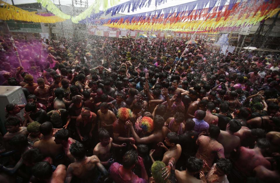 Indians throw squirt water and dance during celebrations marking Holi, the Hindu festival of colors, in Gauhati, India, Monday, March 17, 2014. The holiday, celebrated mainly in India and Nepal, marks the beginning of spring and the triumph of good over evil. (AP Photo/Anupam Nath)