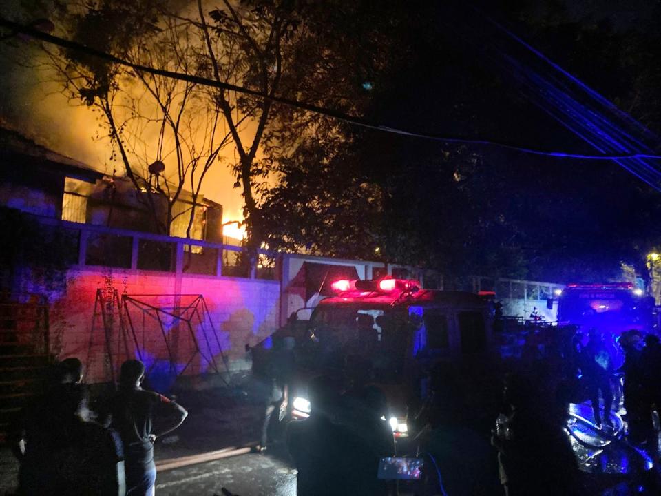 Firefighters try to douse a fire at the Sri Lankan prime minister Ranil Wickremesinghe's private residence (AP Photo/ Eranga Jayawardena)