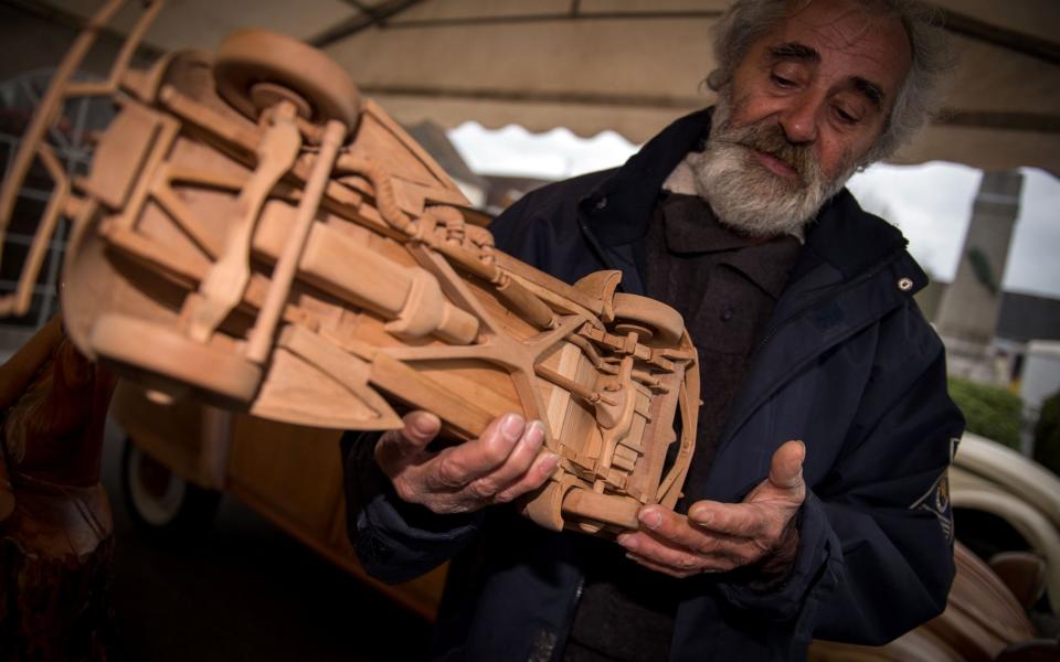 Michel Robillard shows one of his wooden model built at his workshop on March 20, 2017, near Loches, Central France. - Credit: Guillaume Souvant/AFP/Getty