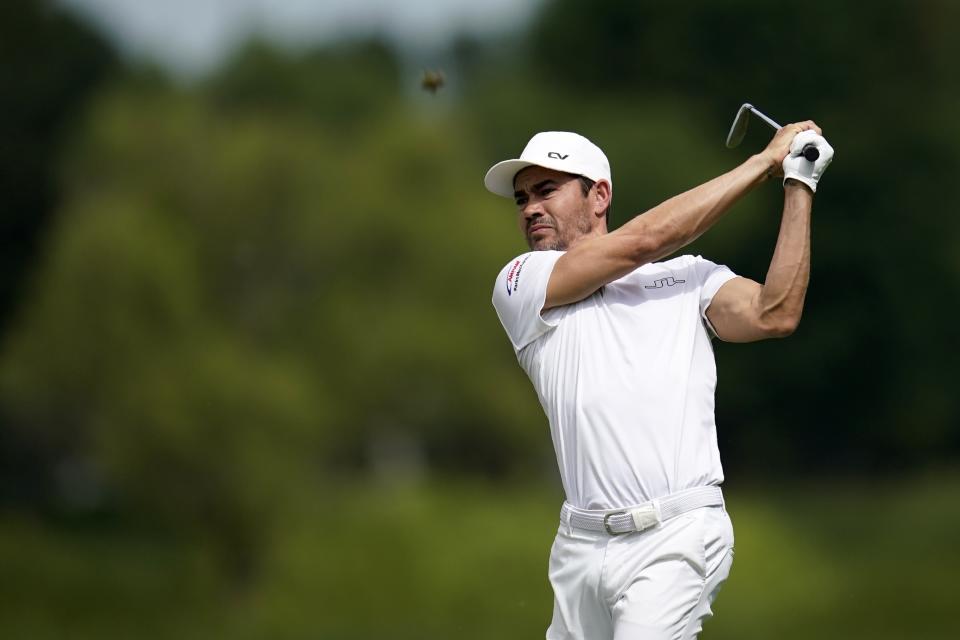 FILE - Camilo Villegas, of Colombia, hits off the 11th fairway during the second round of the 3M Open golf tournament at the Tournament Players Club in Blaine, Minn., Friday, July 22, 2022. Villegas is back in the Masters for the first time in nine years. (AP Photo/Abbie Parr, File)