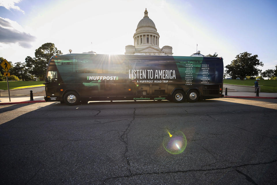The HuffPost bus sits in front of the Arkansas State Capitol during a visit to Little Rock, Arkansas, on Sept. 13,&nbsp;as part of "Listen To America: A HuffPost Road Trip." The outlet will visit more than 20 cities on its tour across the country.