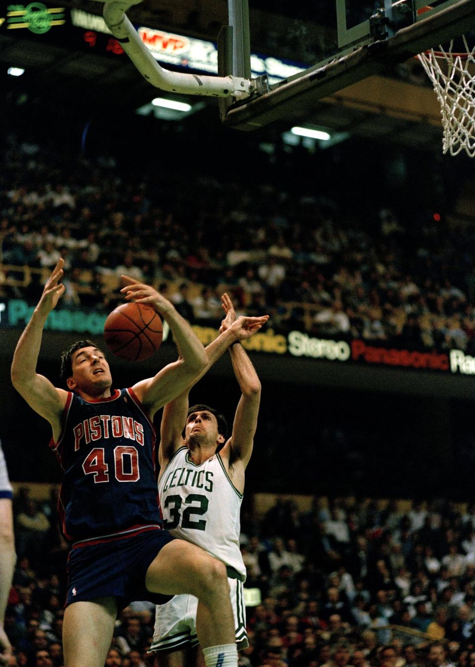 Bill Laimbeer (40) of the Detroit Pistons and Kevin McHale (32) of the Boston Celtics go for a rebound during their game at Boston Garden in Boston, Mass., April 20, 1988. The Celtics won 121-110, clinching a home playoff berth in the upcoming NBA conference playoffs. (AP Photo/Carol Francavilla)