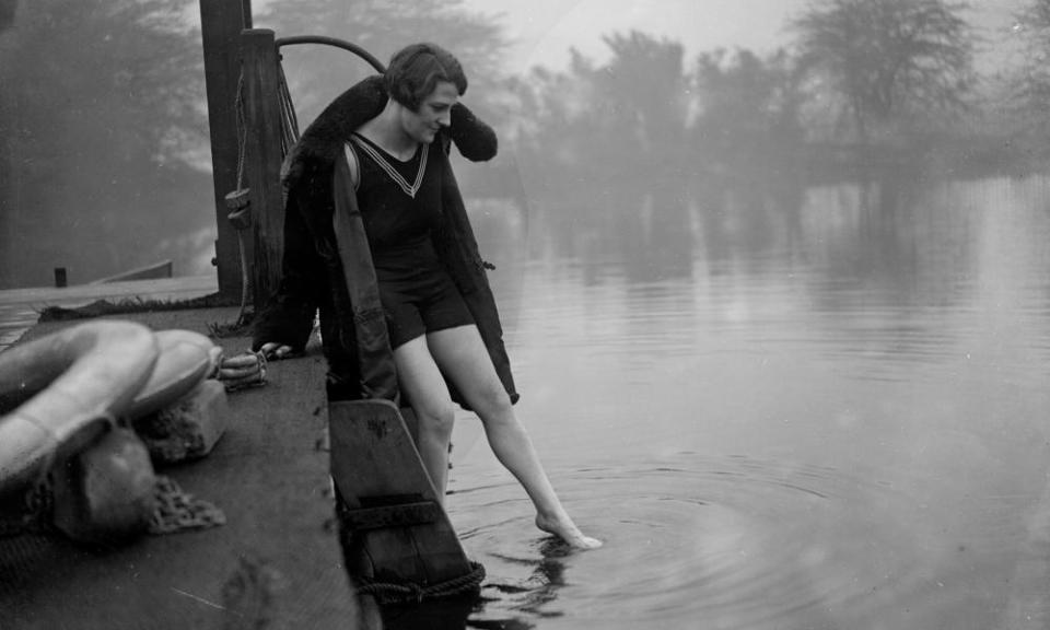 A winter bather, circa 1930, tests the water.